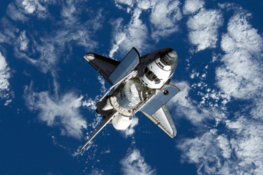 Space shuttle Discovery approaches International Space Station during STS-120 mission.